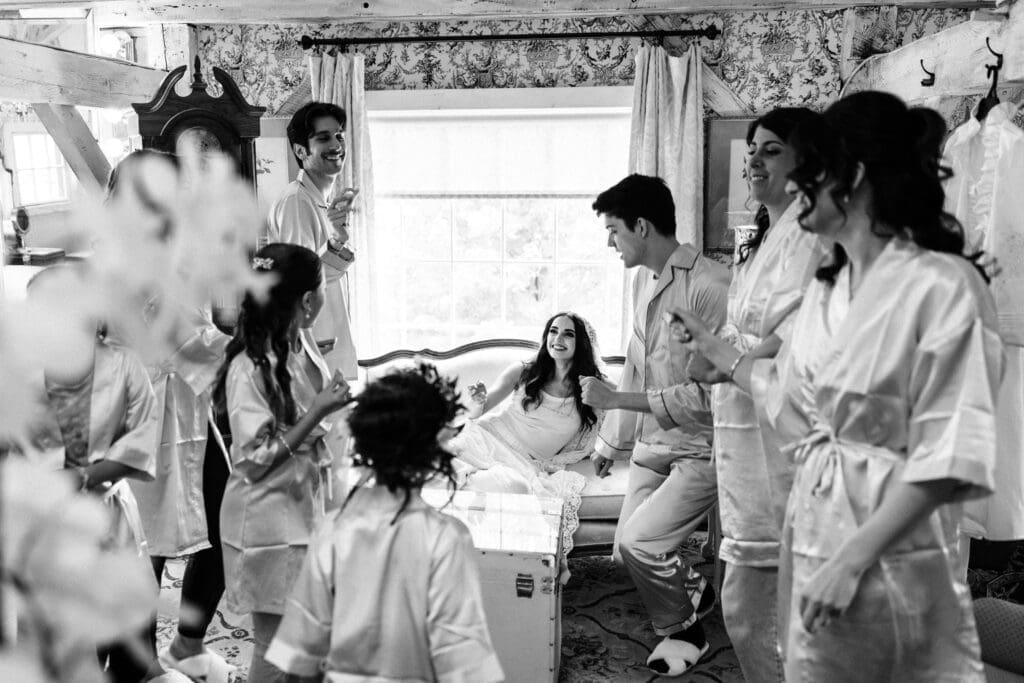 Playful photograph of wedding party dancing while getting ready at Jack's Barn.