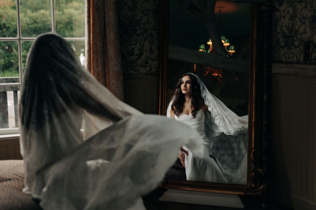 Cinematic photograph of bride and her veil in dramatic lighting. 