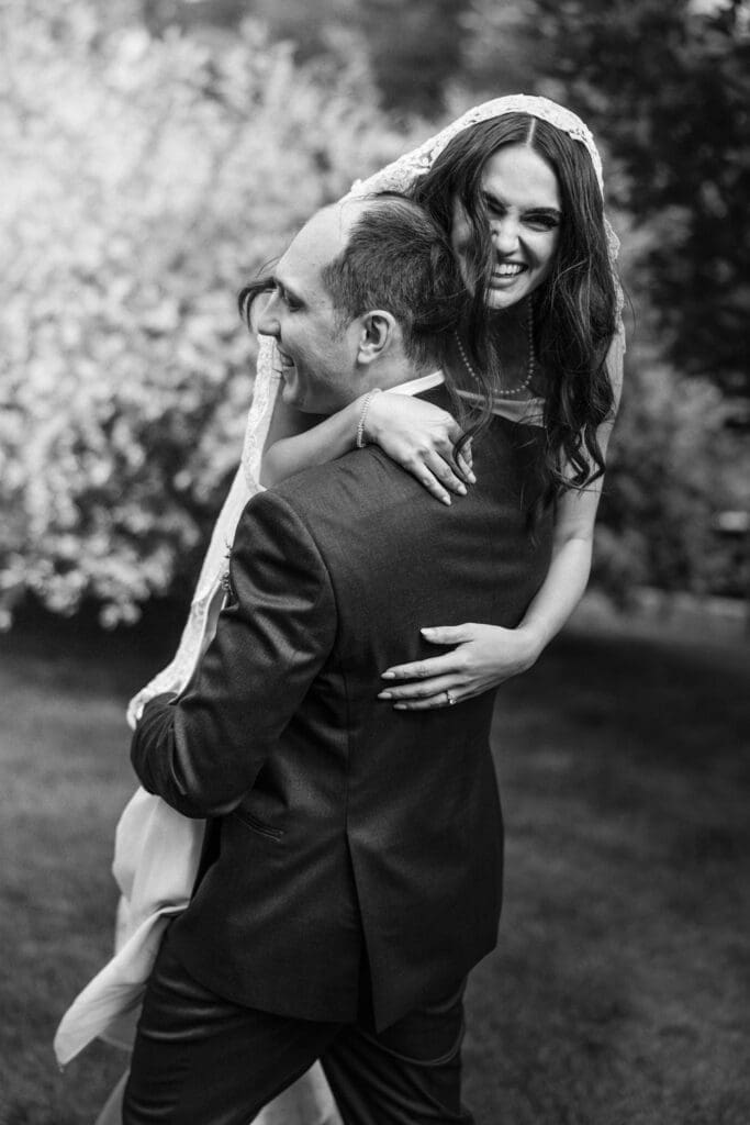 Groom playfully carrying his bride at their New Jersey wedding. 