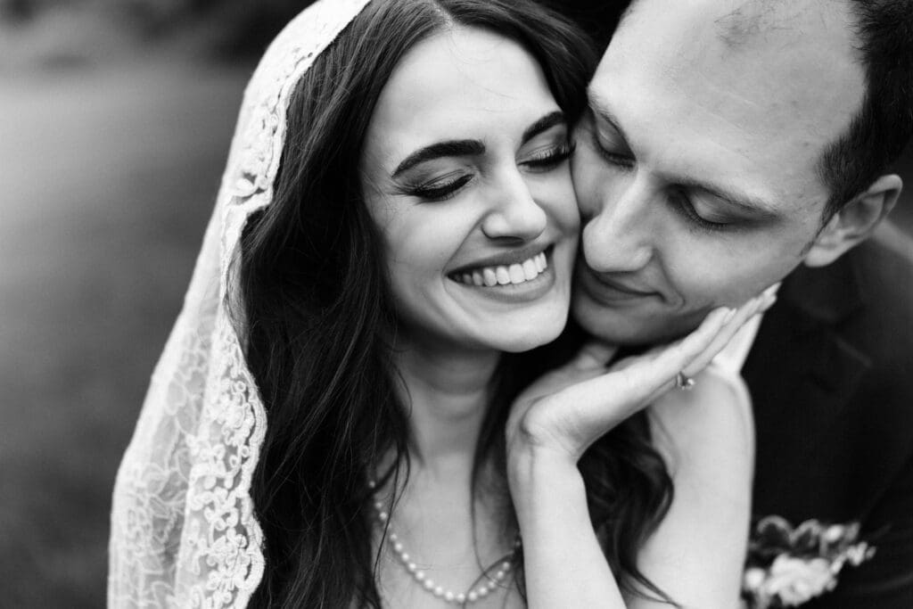 Intimate portrait of bride and groom snuggling on their wedding day at Jack's Barn.