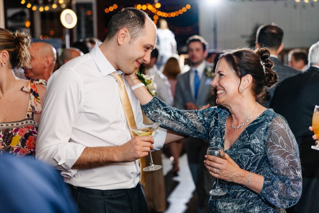 Mother in law and son in law share a moment at wedding reception in New Jersey.