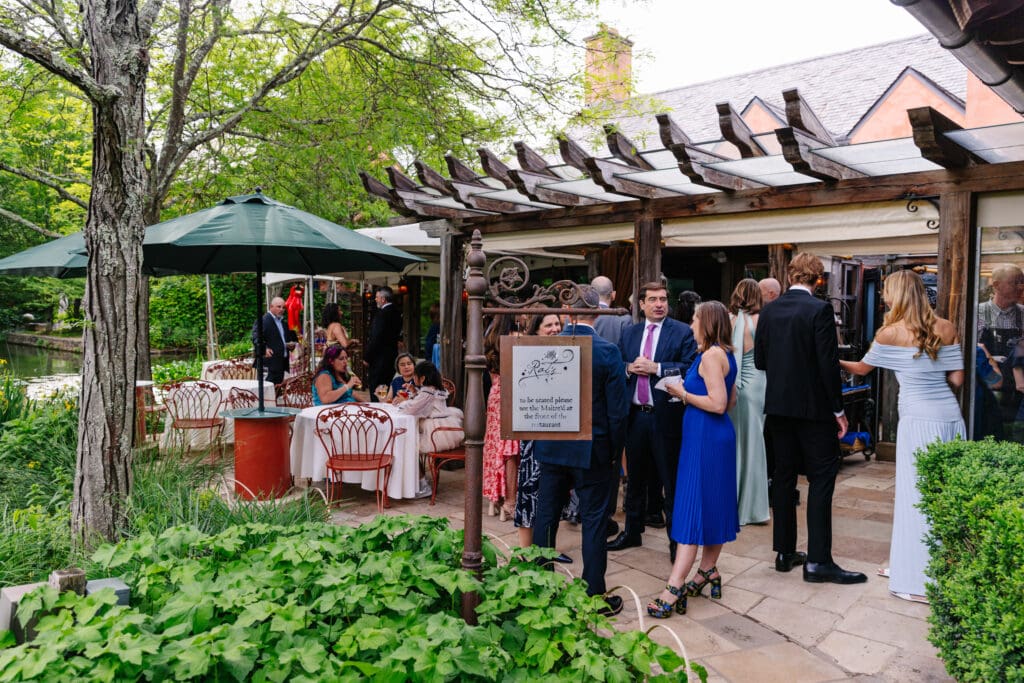 Guests gathering on the terrace at Rat's Restaurant before a wedding anniversary vow renewal in Hamilton Township, NJ.