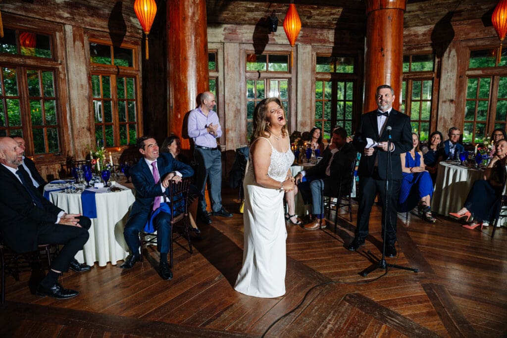 Bride laughing during anniversary speeches inside The Pavilion at Rat's Restaurant.