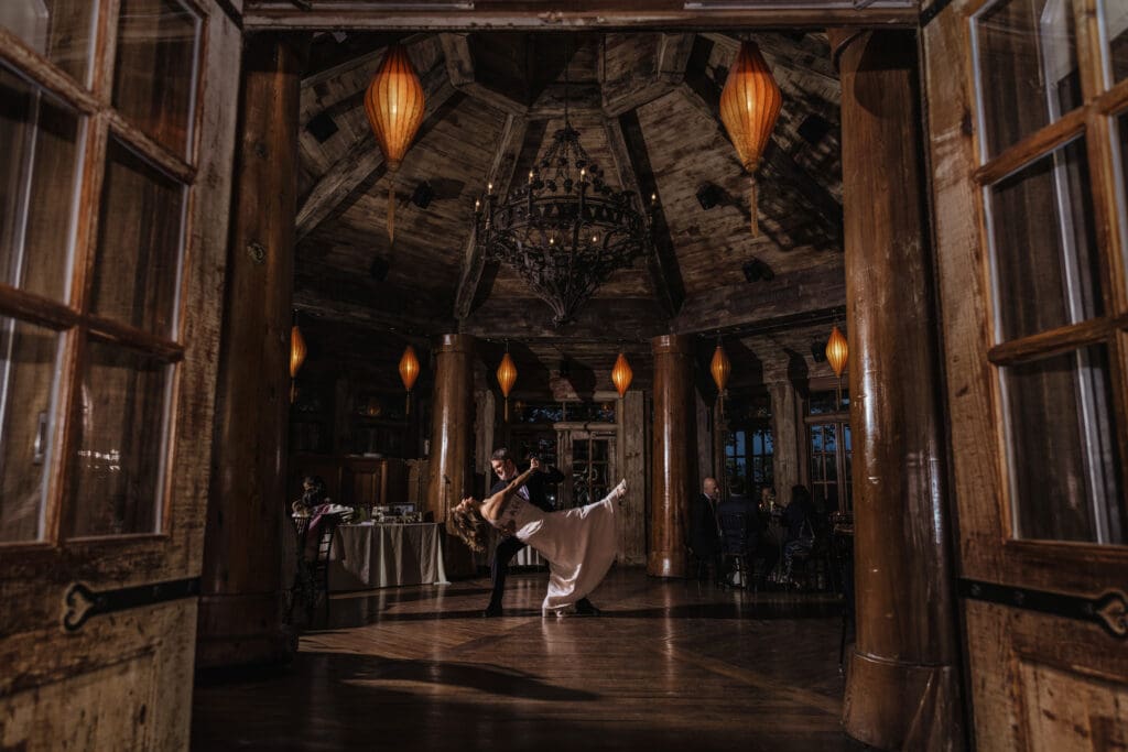 Anniversary couple dancing beneath warm lanterns in the Pavilion Room at Rat's Restaurant in Hamilton Township, NJ.