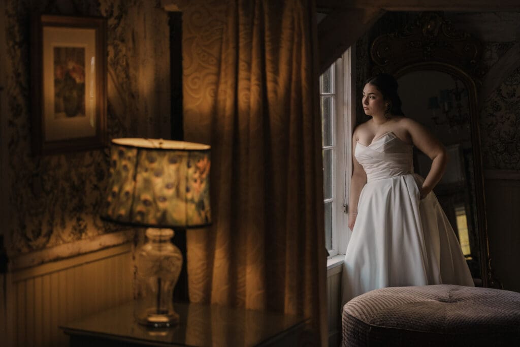 Bride looking out the window at Jack's Barn.